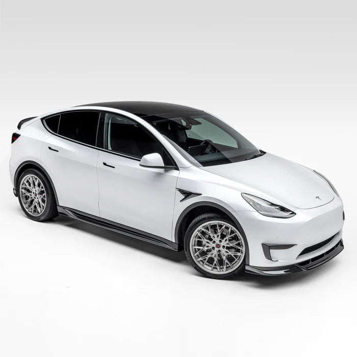 A wide side view of Vorsteiner VRS Aero Front Spoiler Carbon Fiber PP 2x2 Glossy on a white car (for Model Y).