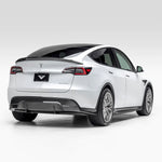 A wide side view of Vorsteiner VRS Aero Rear Diffuser Carbon Fiber PP 2x2 Glossy fitted on white car from behind (for Model Y).