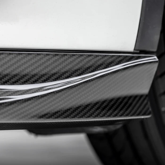 A close up view of Vorsteiner VRS Aero Side Skirts Carbon Fiber PP 2x2 Glossy (for Model Y).