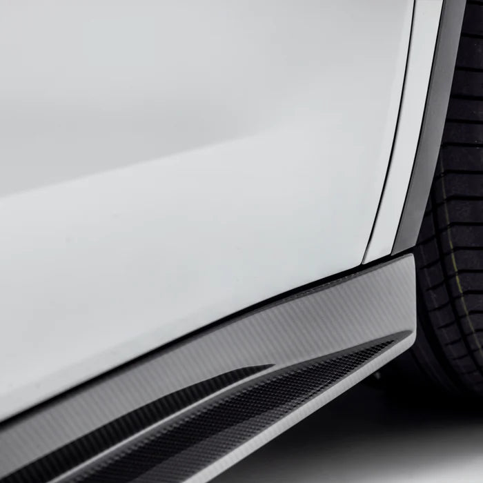 A close up view of Vorsteiner VRS Aero Side Skirts Carbon Fiber PP 2x2 Glossy (for Model Y).