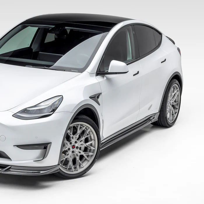 A side view of Vorsteiner VRS Aero Side Skirts Carbon Fiber PP 2x2 Glossy fitted on a white car (for Model Y).