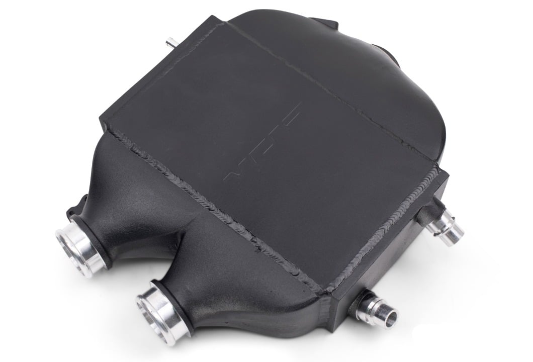 Underside of the VRSF S55 top mount intercooler showing both charge pipe necks and coolant ports