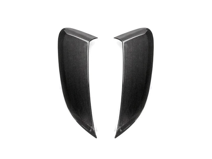 A front view of AUTOTECKNIC DRY CARBON GT4 STYLE SIDE INTAKE SCOOPS - PORSCHE 718 CAYMAN | BOXSTER 2016+ with white background