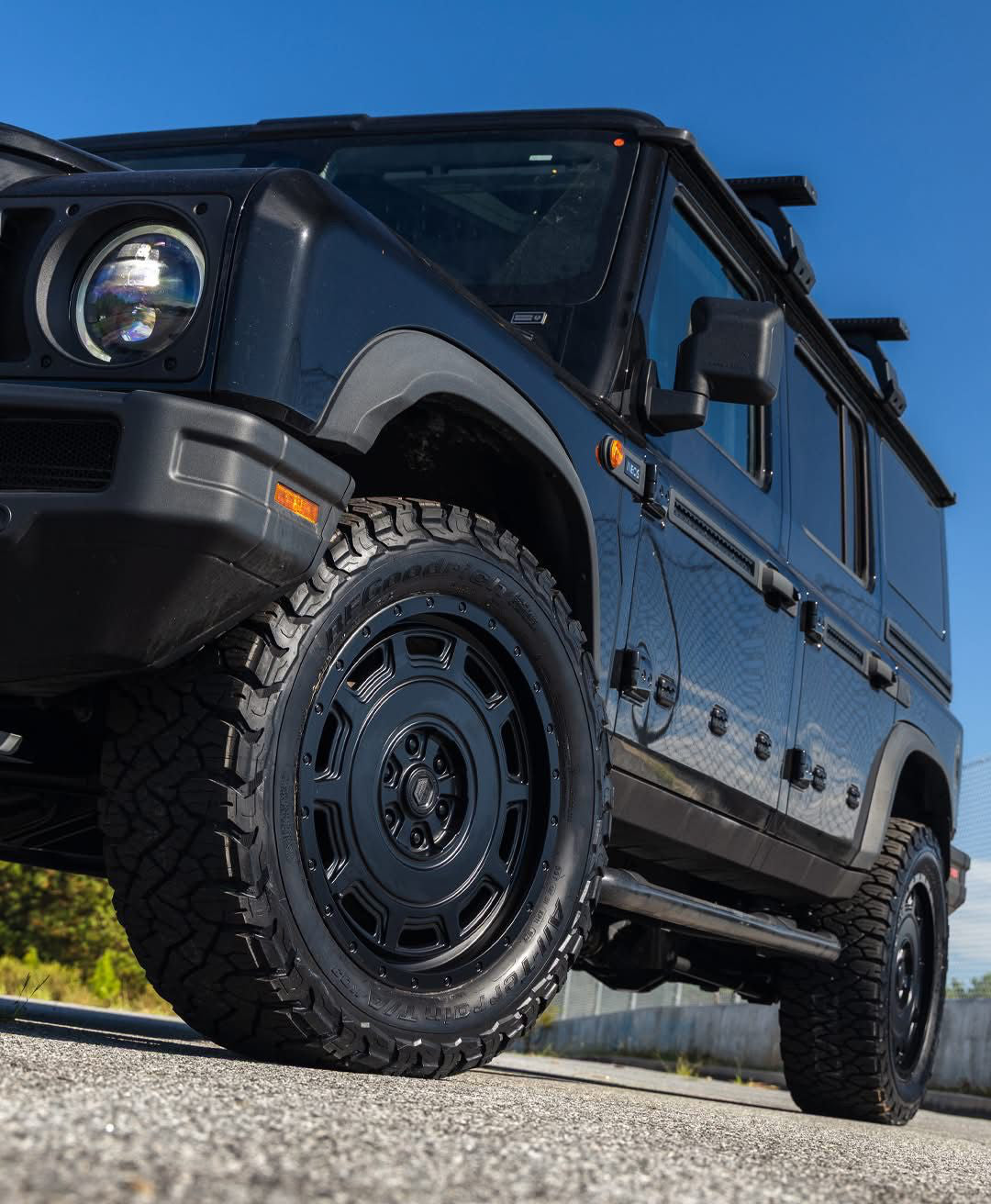 Urban WX4 satin black wheels on an INEOS Grenadier, front three-quarter close-up (other accessories shown are not included)