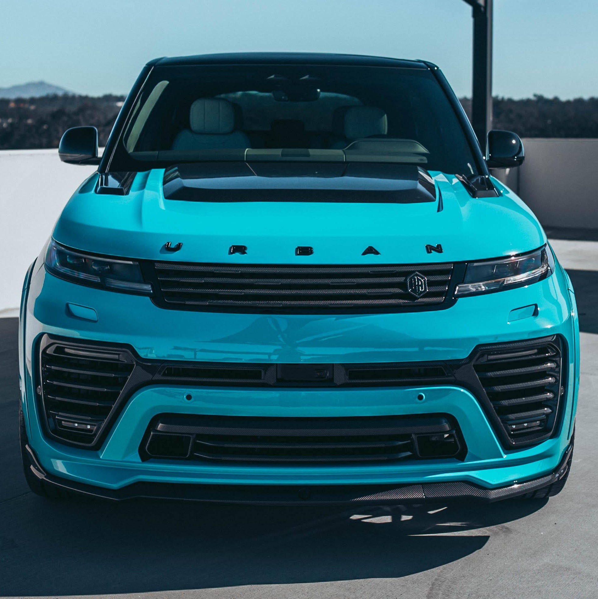 Front view of a blue Range Rover Sport L461 fitted with the Urban Powerdome hood