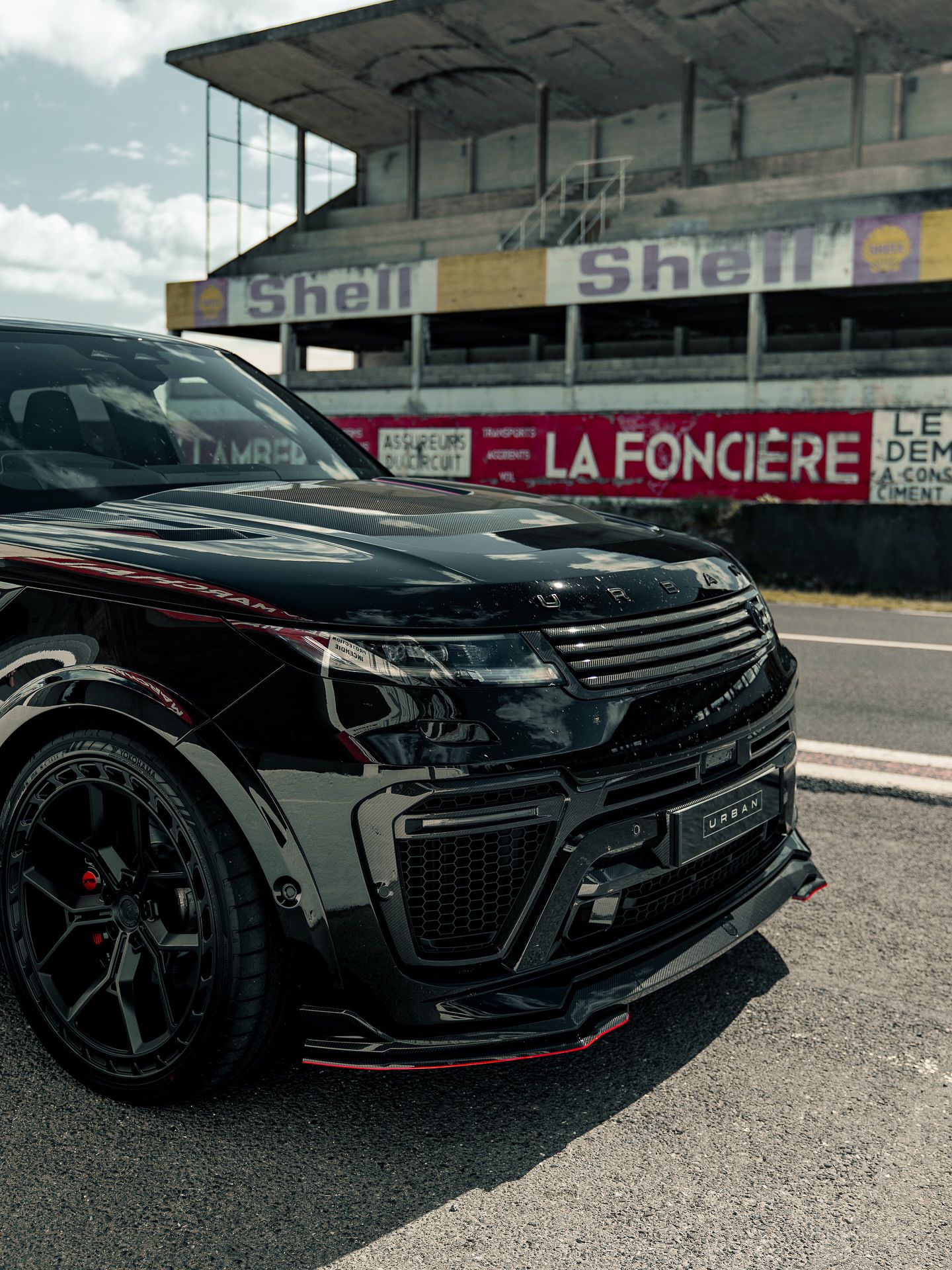 Front corner of the Urban XRS Range Rover Sport at a race circuit