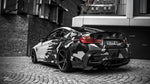 Camouflage-wrapped BMW M4 rear three-quarter with Capristo valved exhaust