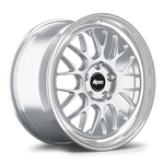 Silver alloy wheel with multi-spoke design and polished lip, black center cap, displayed at three-quarter angle - APEX Wheels wheel for 18x9 ET46 5x130 - Brushed Clear - Machined Lip