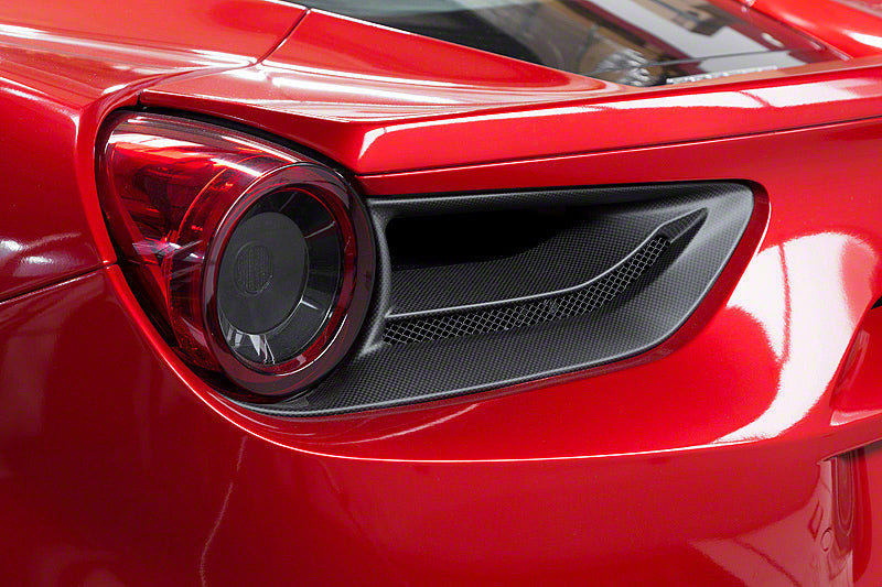 Capristo carbon fiber tail light covers for the Ferrari 488 on a red car