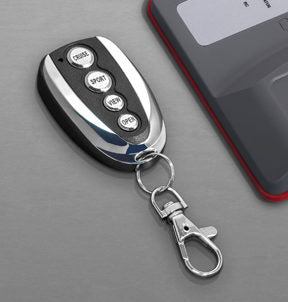 wide top view of Key Fob for Capristo Remote with grey background
