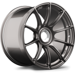 Gunmetal forged wheel with ten-spoke design, center bore visible, positioned at angle on white background - APEX Wheels wheel for 19x12 ET47 PSCL - Anthracite