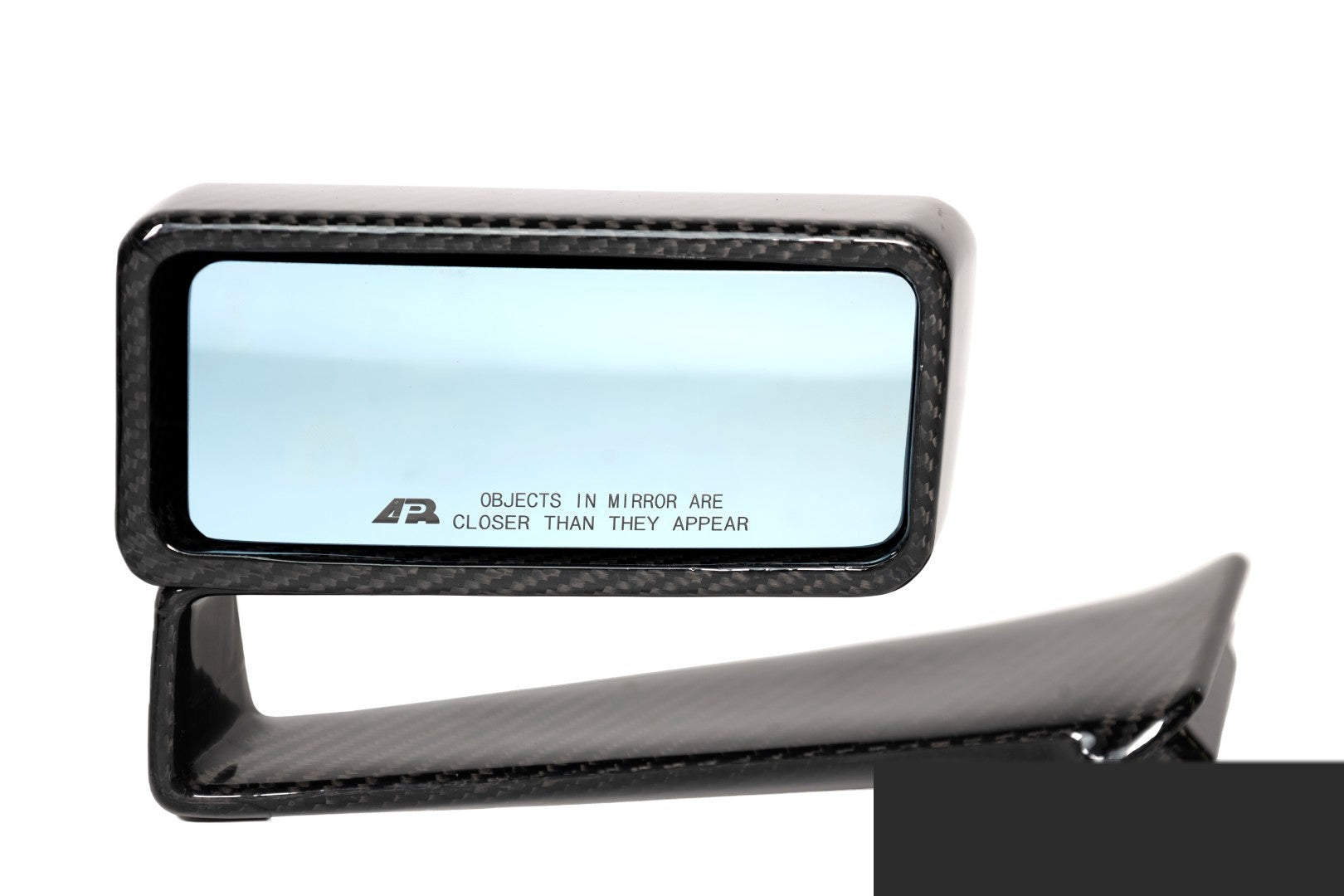 Rectangular side mirror with carbon fiber frame and blue tinted glass showing warning text etched on surface - APR Performance side mirror for Ford S650 Mustang Dark Horse