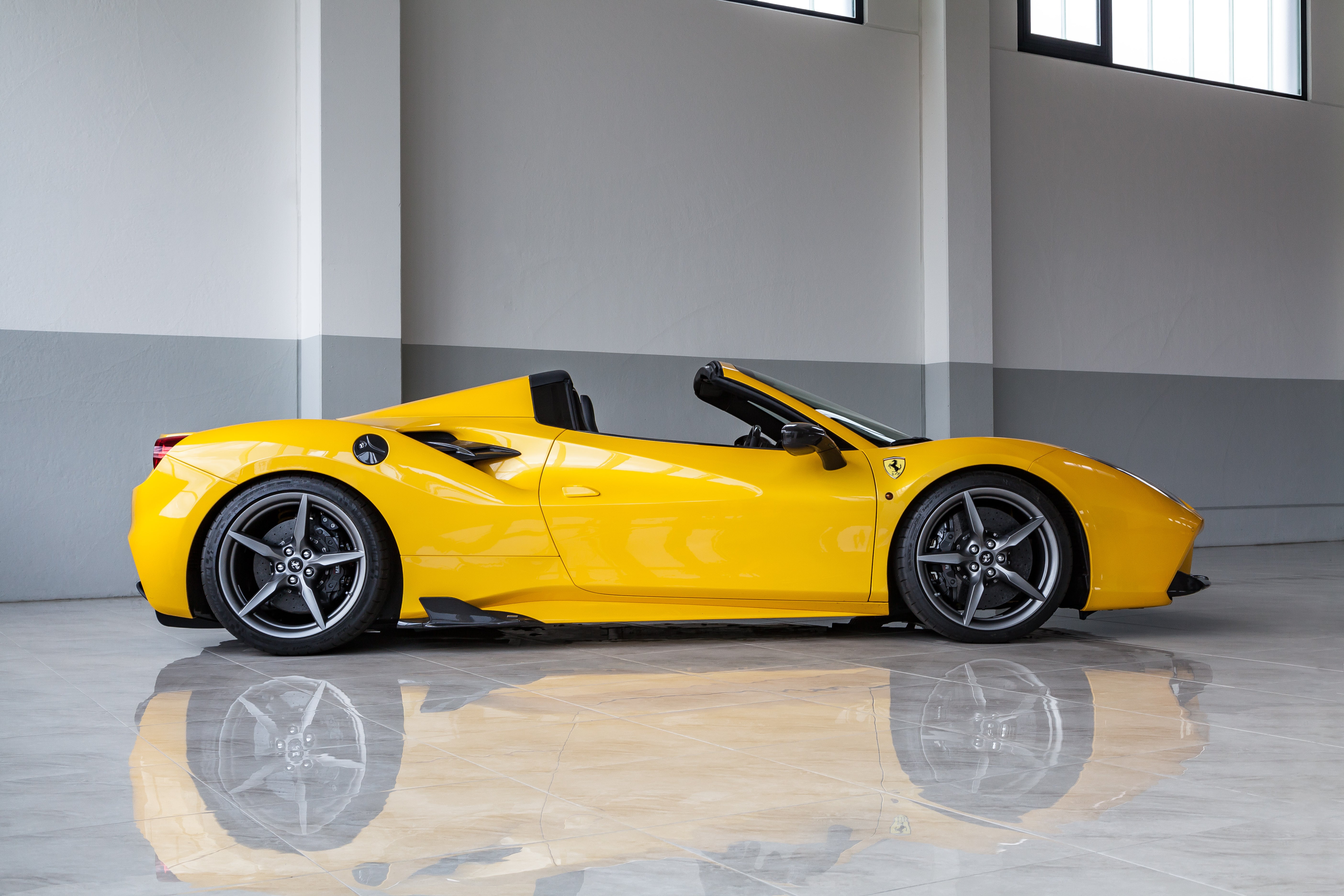 Yellow Ferrari 488 Spider profile with Capristo carbon side fins