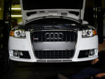 A front view of Evolution Racewerks Audi A4 (B7) Sports Series Dual Side Mount Intercooler (SMIC) Upgrade Kit installed in an Audi car on the ground
