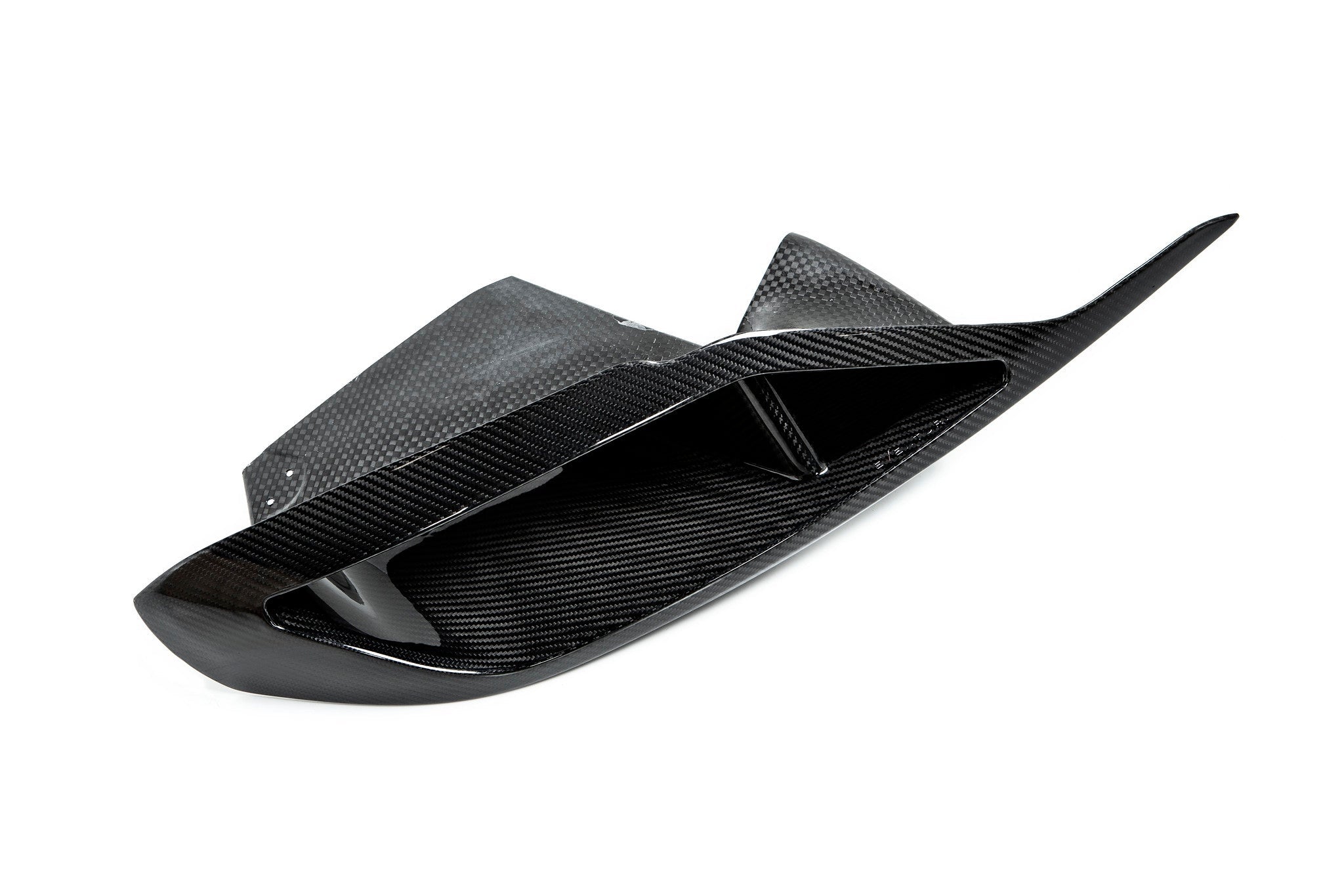 Carbon fiber headlamp duct with curved aerodynamic shape and internal air channeling fins on white background - Eventuri headlamp duct for Toyota Supra