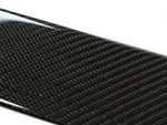 A close up view of AUTOTECKNIC DRY CARBON FIBER SIDE SILL SET - BMW F97 X3M | F98 X4M 2019+ with white background