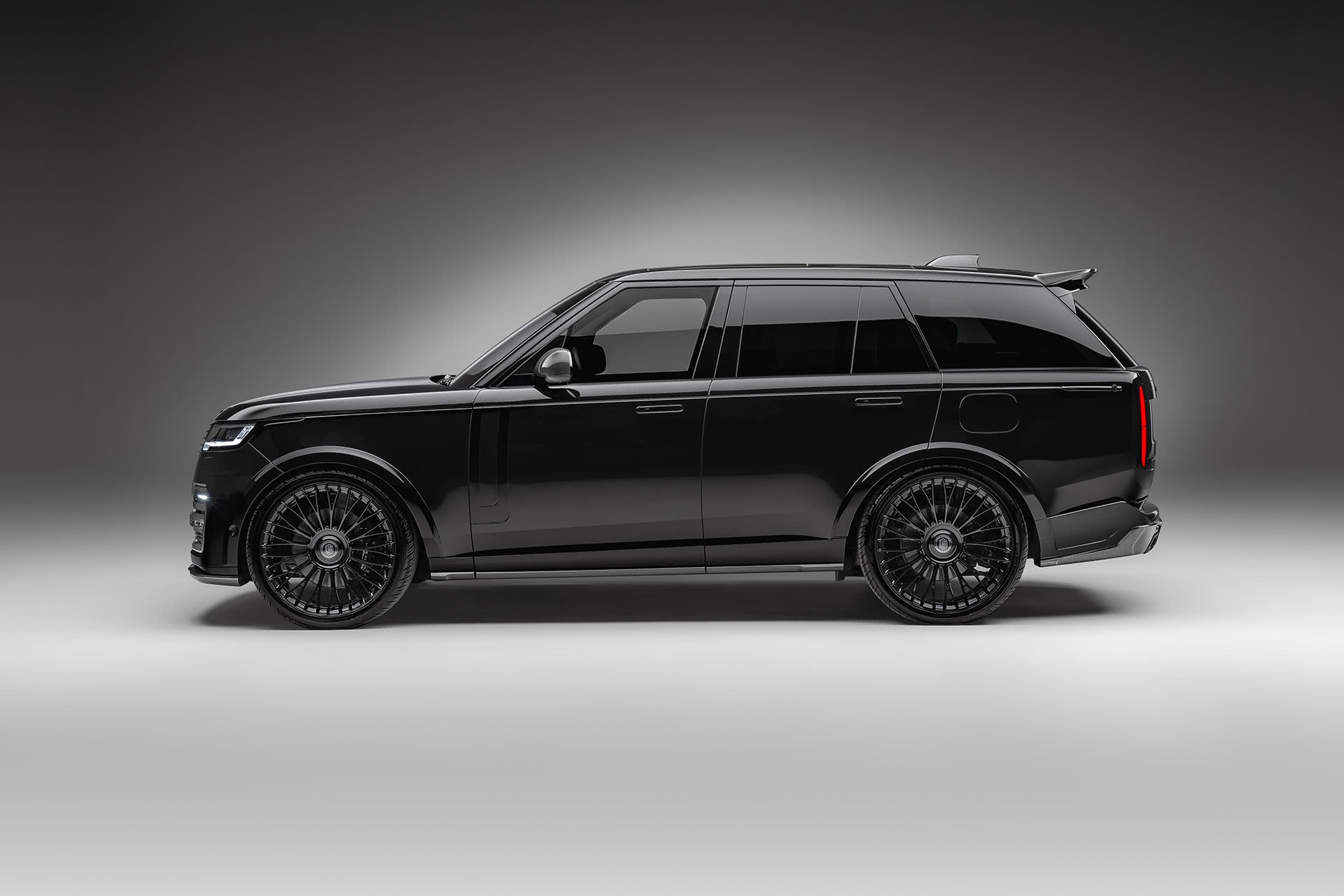 Side profile of a black Range Rover L460 Urban Widetrack with wide arches and carbon sills