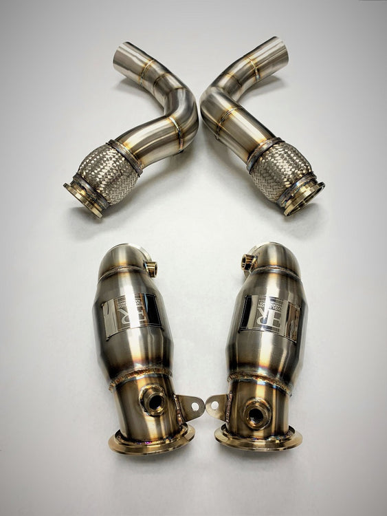 A top view of Evolution Racewerks Sports Series High Flow Catted Downpipe for BMW X5M/X6M S63M Engine in Brushed Finish