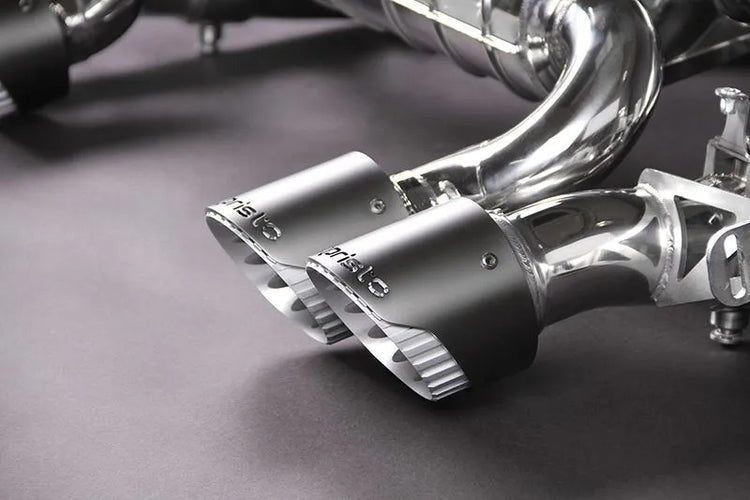 Wide view of Capristo Valved Exhaust, Middle Silencer Delete & Wicrom Tips (OE Actuators) for BMW M3/M4 G8X 2021-2024 with black background