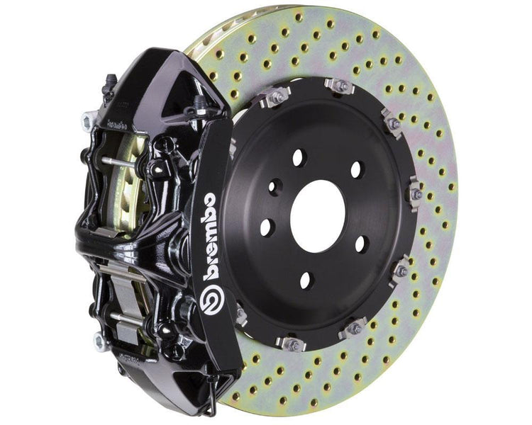 A front view of Brembo GT Front Big Brake Kit 380x34 6-Piston Drilled Rotors for Volkswagen Tiguan R (Mk2) in black caliper with white background