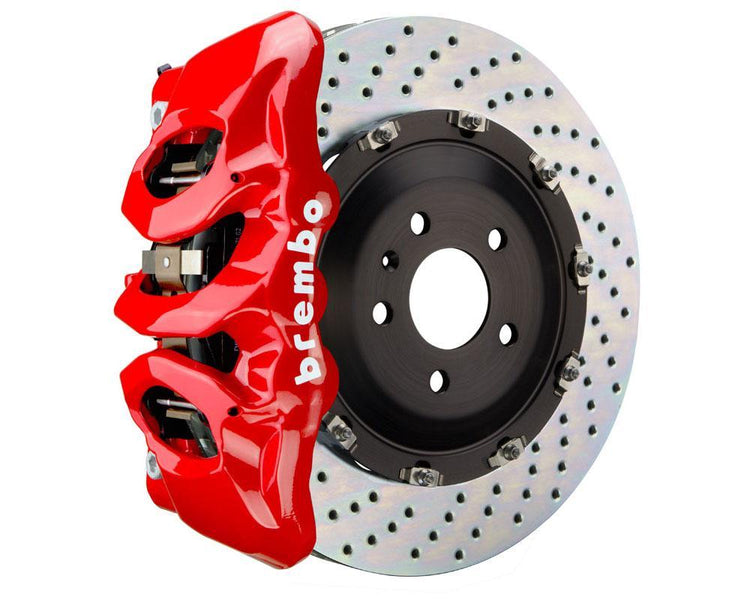 A front view of Brembo GT Front Big Brake Kit 380x34 6-Piston Drilled Rotors for Audi S3 (8Y) in red caliper with white background