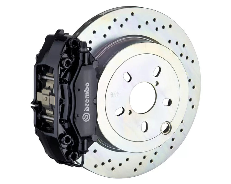 A front view of Brembo GT Rear Big Brake Kit 309x28 1-Piece 4-Piston Drilled Rotors for Porsche 911S / SC / Carrera 1966-1989 with black caliper