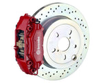 A front view of Brembo GT Rear Big Brake Kit 309x28 1-Piece 4-Piston Drilled Rotors for Porsche 911S / SC / Carrera 1966-1989 with red caliper