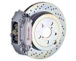A front view of Brembo GT Rear Big Brake Kit 309x28 1-Piece 4-Piston Drilled Rotors for Porsche 911S / SC / Carrera 1966-1989 with silver caliper
