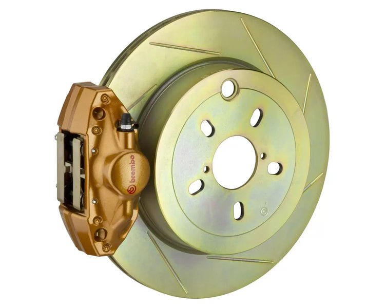 A front view of Brembo GT Rear Big Brake Kit 316x20 1-Piece 2-Piston Slotted Rotors for Subaru Legacy / WRX 2010-2022 with gold caliper with white background
