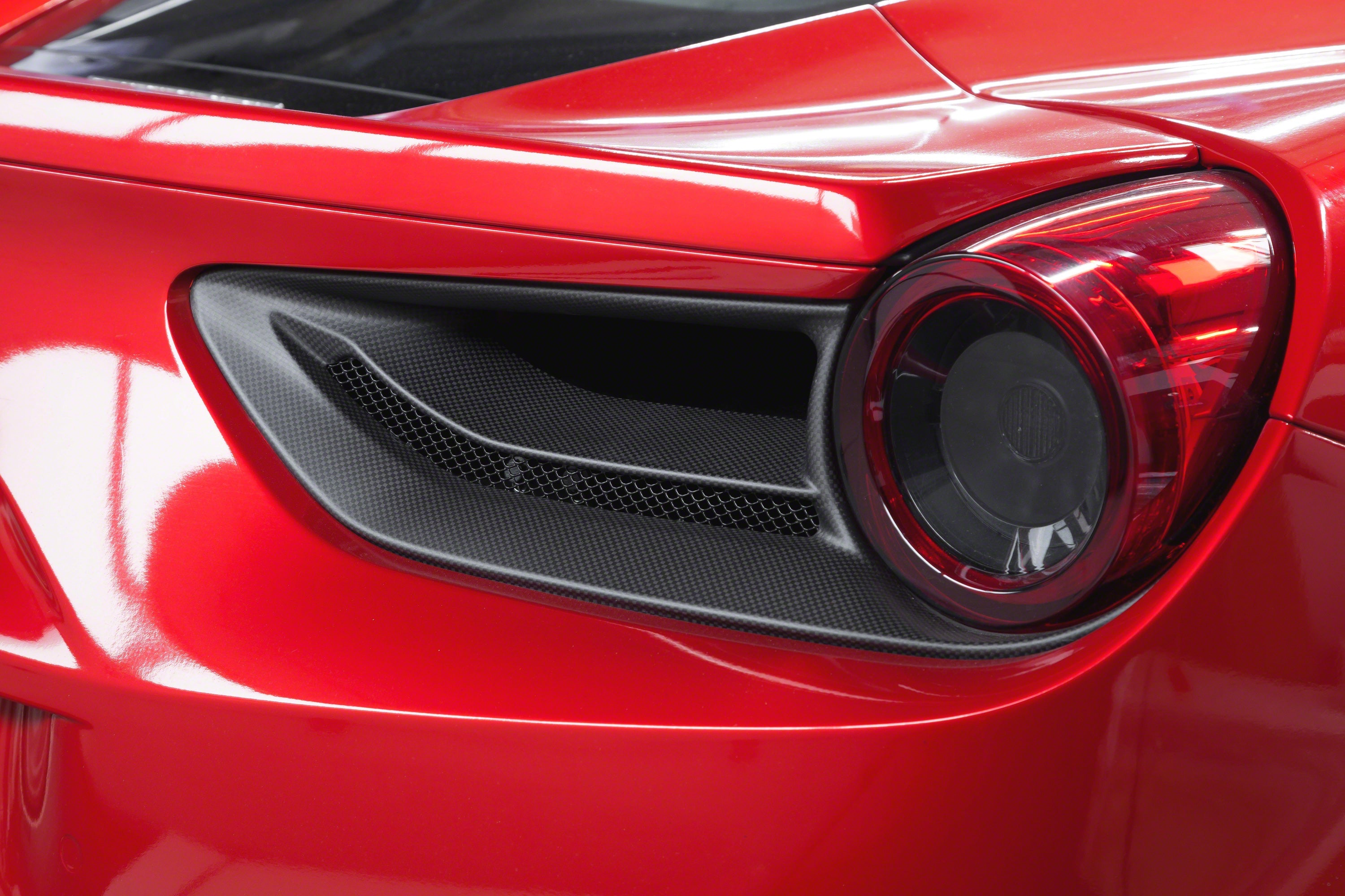 Capristo carbon fiber tail light covers for the Ferrari 488 on a red car, side angle