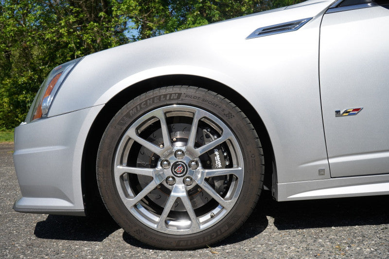 A close up view of a car's front wheel fitted with AP Racing by Essex Radi-CAL ENP Competition Brake Kit (Front CP9660/372mm)- Cadillac CTS-V 2009-2015 (V2)