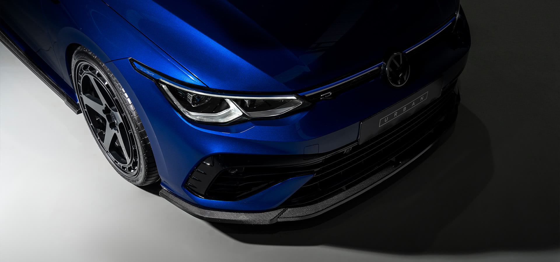 Close-up of the Urban carbon front apron on a blue VW Golf R Mk8