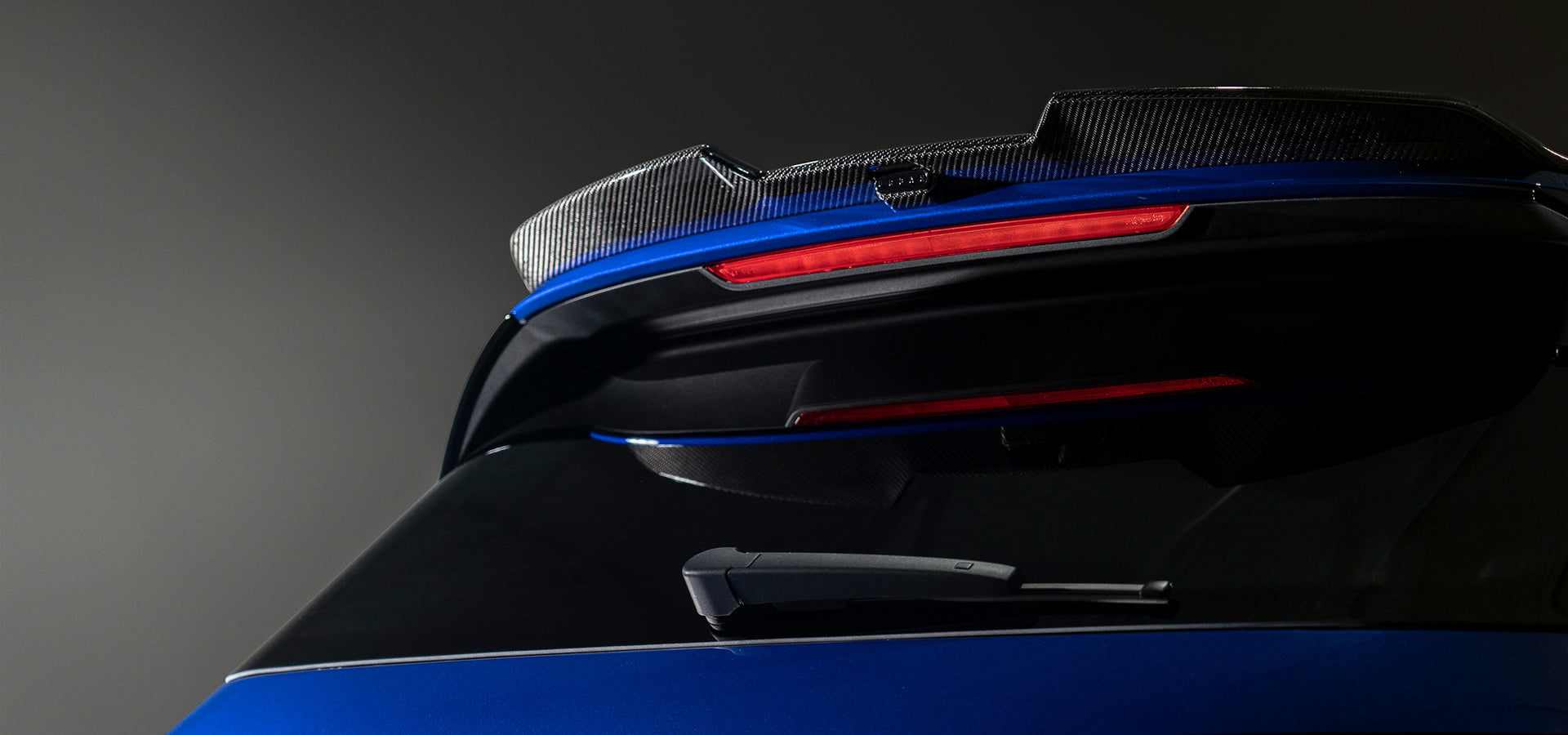 Urban carbon upper rear wing on a blue VW Golf R Mk8