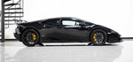 Rear three-quarter view of a black Lamborghini Huracan with the Urban carbon rear wing
