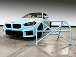 CMS Performance Roll Bar for BMW G87 M2 (2023+) - Red powder coat finish, full roll bar standalone on concrete floor - AutoTalent