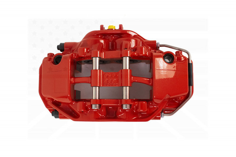 A top view of the red caliper of the AP Racing by Essex Road Brake Kit (Rear 9541/380mm)- F87 BMW M2, F80 M3, F82 M4 with a white background