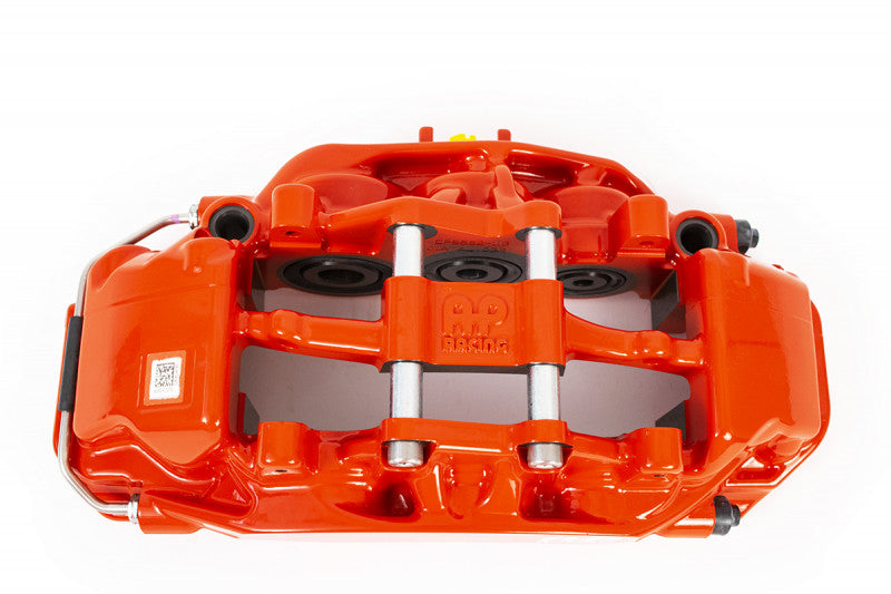A top view of a red caliper of the AP Racing by Essex Road Brake Kit (Front 9561/380mm)- C7 Corvette with a white background