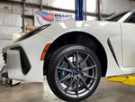 A close up view of a white car and its front wheel fitted with AP Racing by Essex Radi-CAL Competition Brake Kit (Front CP9668/355mm)- Subaru BRZ, Scion FR-S & Toyota GT86/GR86 2013+