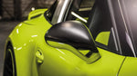 A close up view of TECHART Standard Side Mirror Shells Matt Carbon Fiber Porsche 991 / 991.2