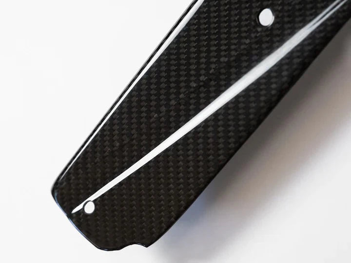 A close up view from the top of AUTOTECKNIC DRY CARBON FIBER SIDE SILL SET - BMW G01 X3 | G02 X4 2018+ with white background