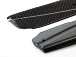 A close up view of AUTOTECKNIC DRY CARBON FIBER SIDE SILL SET - BMW F97 X3M | F98 X4M 2019+ with white background