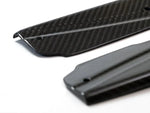 A close up view of AUTOTECKNIC DRY CARBON FIBER SIDE SILL SET - BMW G01 X3 | G02 X4 2018+ with white background