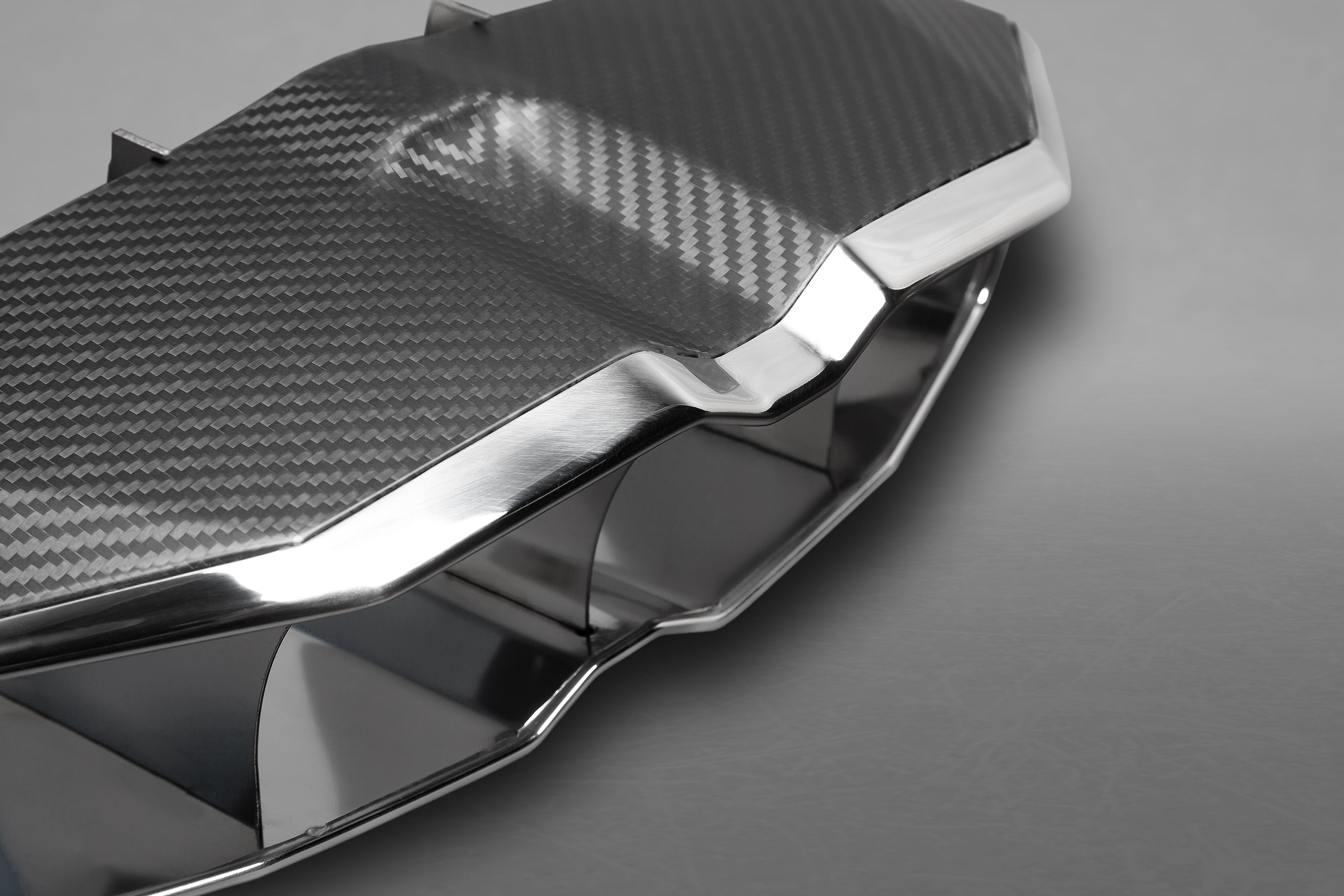 Close-up of carbon fiber weave and polished stainless edge on Capristo Aventador SV tip frame