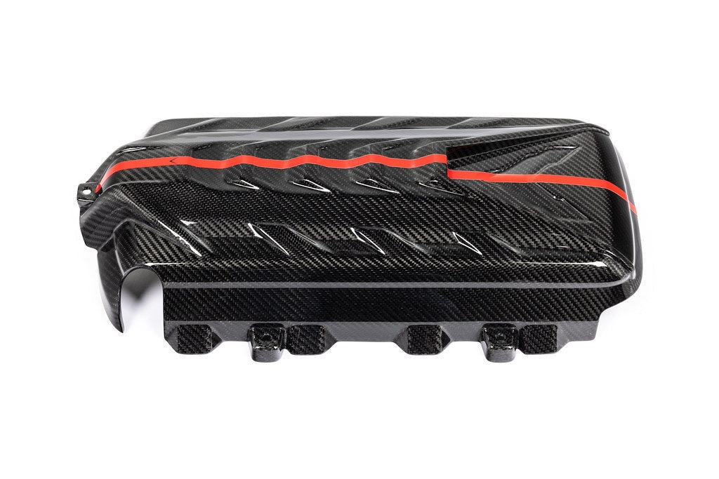 Carbon fiber engine cover with red accent stripe and angular vents on clean white background - Eventuri engine cover for Chevrolet Corvette