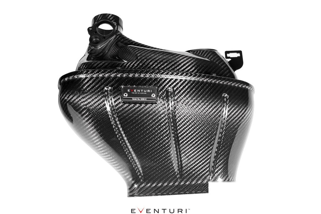 Carbon fiber cold air intake housing with distinctive angular geometry and integrated mounting brackets on white background - Eventuri cold air intake for Mercedes-Benz G63 AMG