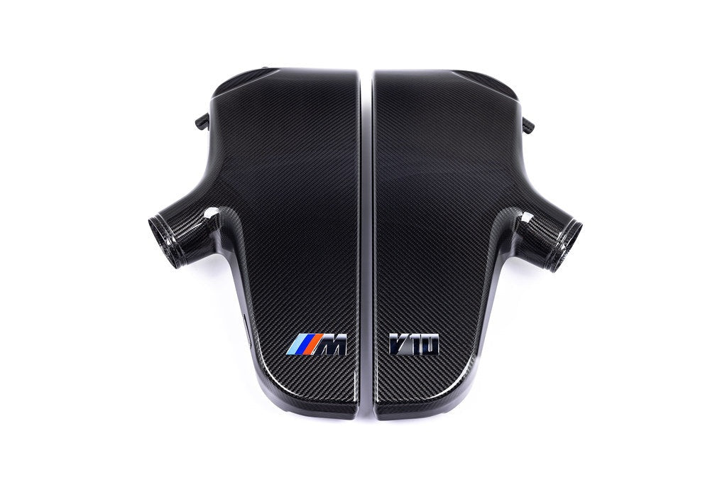Two-piece carbon fiber inlet plenum with curved chambers and side-mounted connection ports on white background - Eventuri inlet plenum for BMW E60 M5 E63 M6