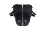 Two-piece carbon fiber inlet plenum with curved chambers and side-mounted connection ports on white background - Eventuri inlet plenum for BMW E60 M5 E63 M6