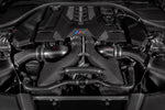 Carbon fiber turbo inlet tubes installed in BMW engine bay with V8 motor visible - Eventuri turbo inlet for BMW F90 M5 F91 F92 F93 M8