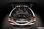 Black carbon fiber air intake system installed in white Corvette engine bay with trunk open showing V8 engine - Eventuri cold air intake for Chevrolet Corvette Stingray