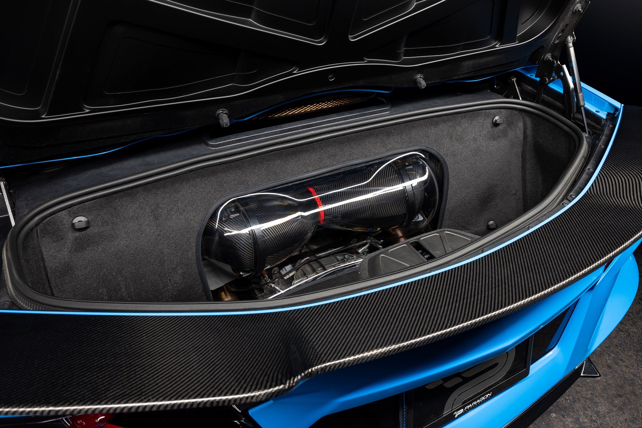 Carbon fiber intake system with red accent stripe installed in Corvette engine bay compartment - Eventuri intake for Chevrolet Corvette
